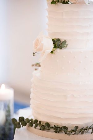 All white wedding cake with greenery foliage detail - Elizabeth Nord Photography