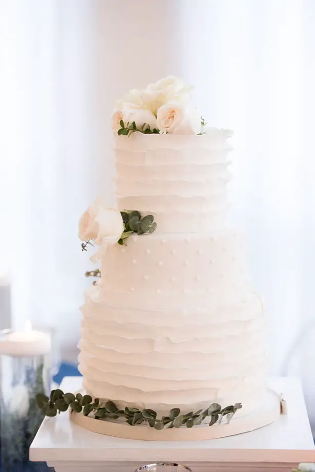 All white wedding cake with greenery foliage detail - Elizabeth Nord Photography