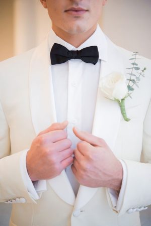 White groom tuxedo with black bow tie - Elizabeth Nord Photography