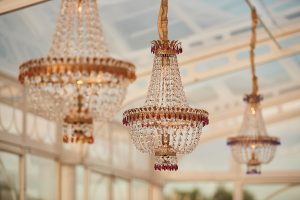 Clear tent luxury wedding chandeliers - Photography: Studio Bonon