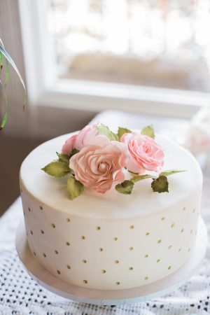 White wedding cake with gold details and flowers - Brooke Images