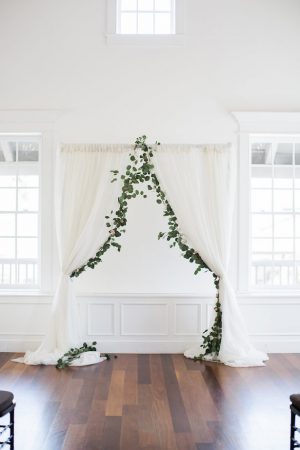 White wedding ceremony decor with greenery - Brooke Images