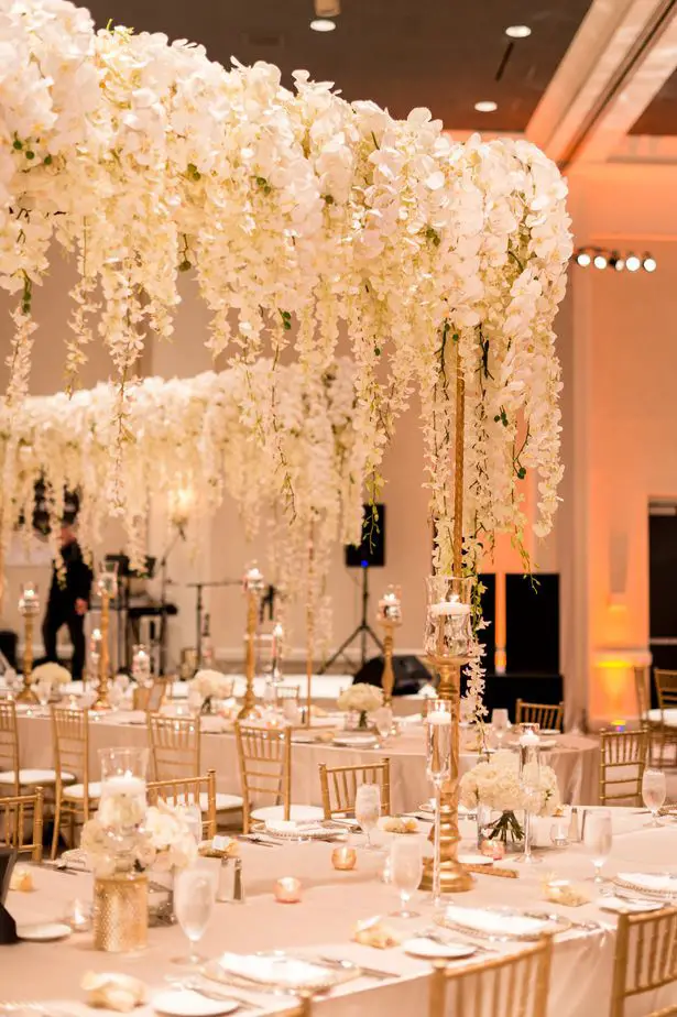 Hanging flower tall wedding centerpiece with white orchids and wisteria - Photographer: Julia Franzosa