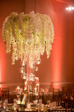 Hanging flower tall wedding centerpiece with white orchids and wisteria - Photographer: Julia Franzosa
