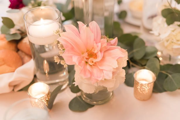 Floating candles and greenery garland wedding centerpiece - Photography by Marirosa