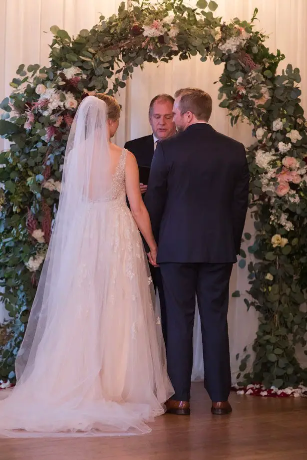 Wedding ceremony decor with greenery arch - Photography by Marirosa