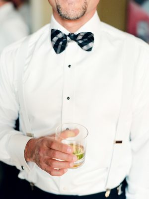 Groom black and white outfit with bow tie - Melissa Schollaert Photography