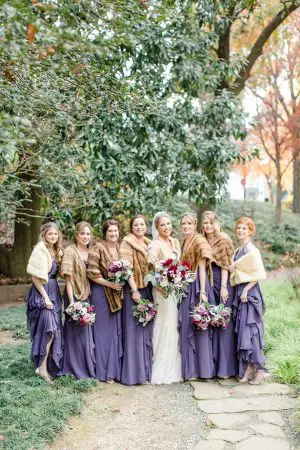 Purple long bridesmaid dresses with a fur cover up for a winter wedding - Melissa Schollaert Photography