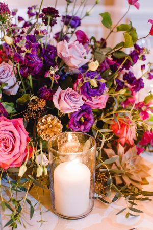 Purple low wedding centerpiece with candlelight - Melissa Schollaert Photography