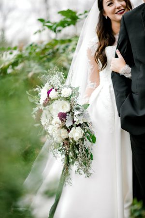 Wild wedding bouquet with white roses and purple carnations - Honey + Bee Photography