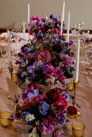 Long tablescape wedding centerpiece with purple flowers -Sherri Barber Photography