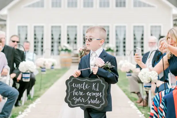 Ring bearer with sign - Photography: Lauren Westra