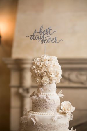 White luxury wedding cake with silver cake topper- Cat Pennenga Photography