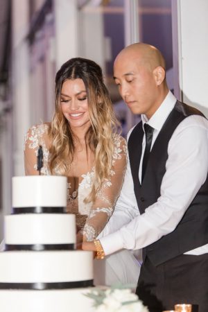 cutting black and white wedding cake - NST Pictures