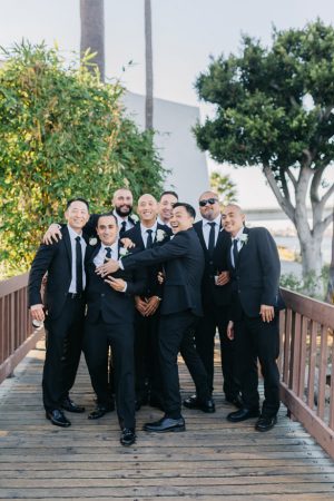 groomsmen matching black suit and tie - NST Pictures