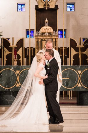Church wedding ceremony kiss - Classic Blush Wedding at The Houston Club - Nate Messarra Photography