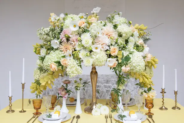 Tall wedding centerpiece for yellow tablescape - Photography: Szu Designs, Inc