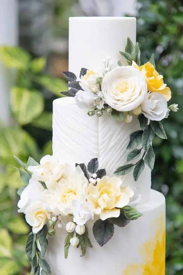 White and yellow wedding cake with fresh flowers - Photography: Szu Designs, Inc