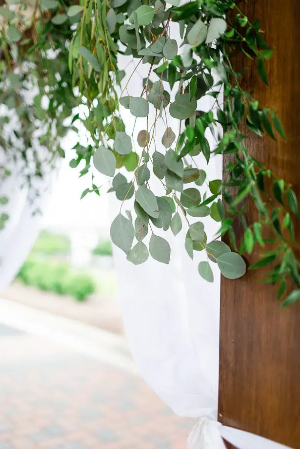 wood wedding arch with greenery - Luke & Ashley Photography