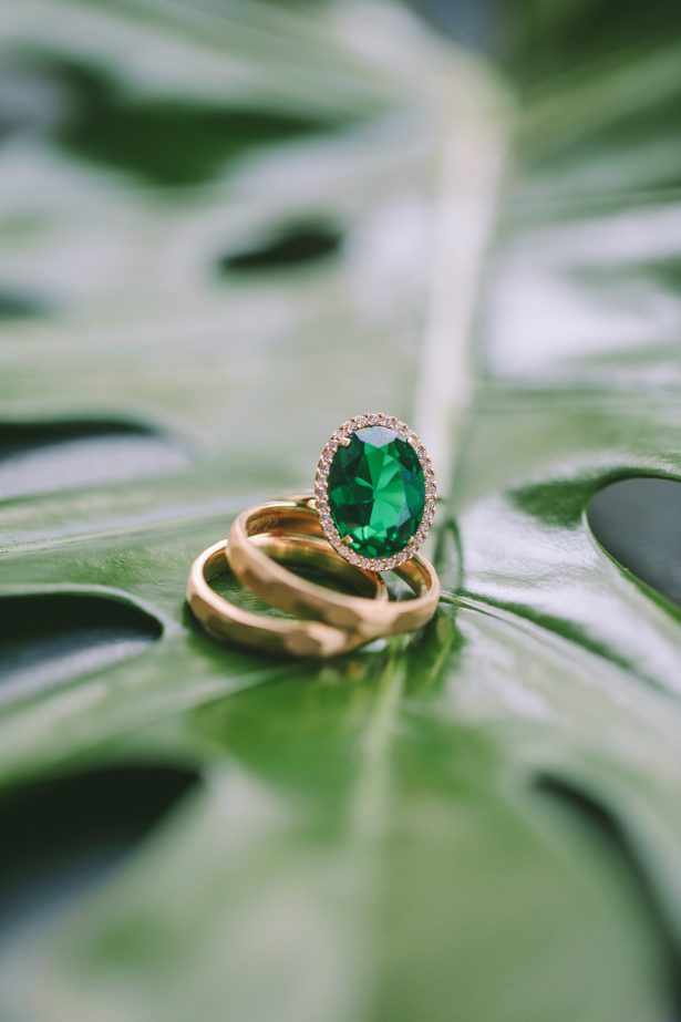 Emerald green and yellow gold engagement ring and wedding bands - George Pahountis Photographer