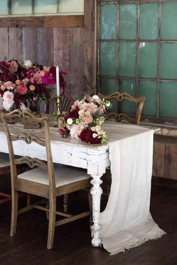 Long wedding tablescape with burgundy centerpieces - Photography: Szu Designs, Inc 
