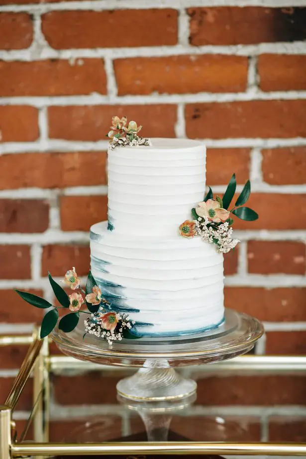 White buttercream wedding cake with blue ombre details and fresh flowers - Amanda Meg Photography