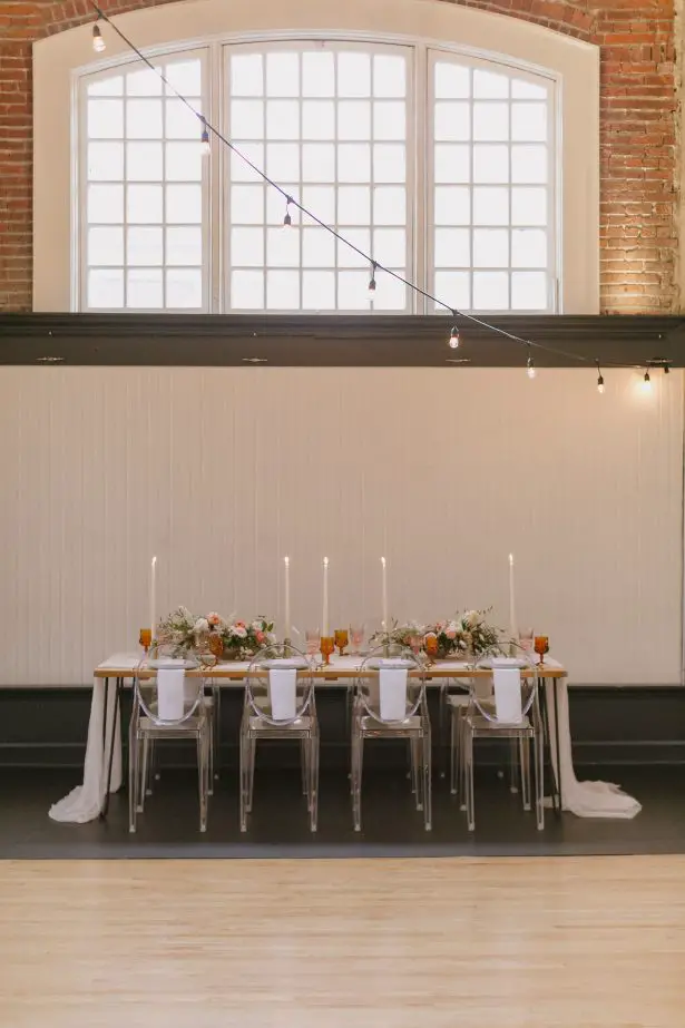 Long Wedding tablescape with modern acrylic chairs - Andrea Zajonc Photography