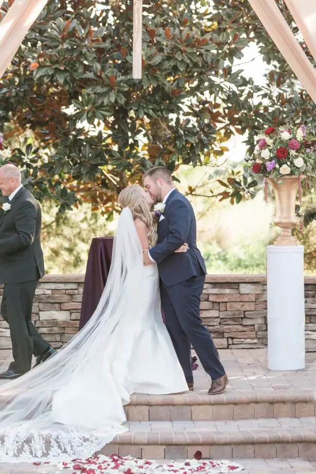 Wedding kiss at and outdoor ceremony - Photography: The Hendricks 