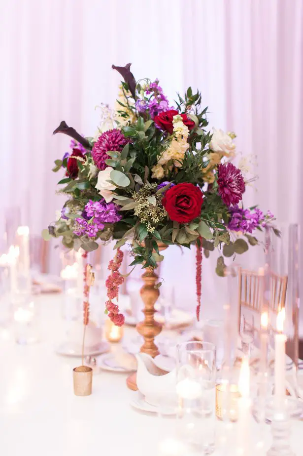 Tall wedding centerpiece with colorful flowers on gold vase - Photography: The Hendricks