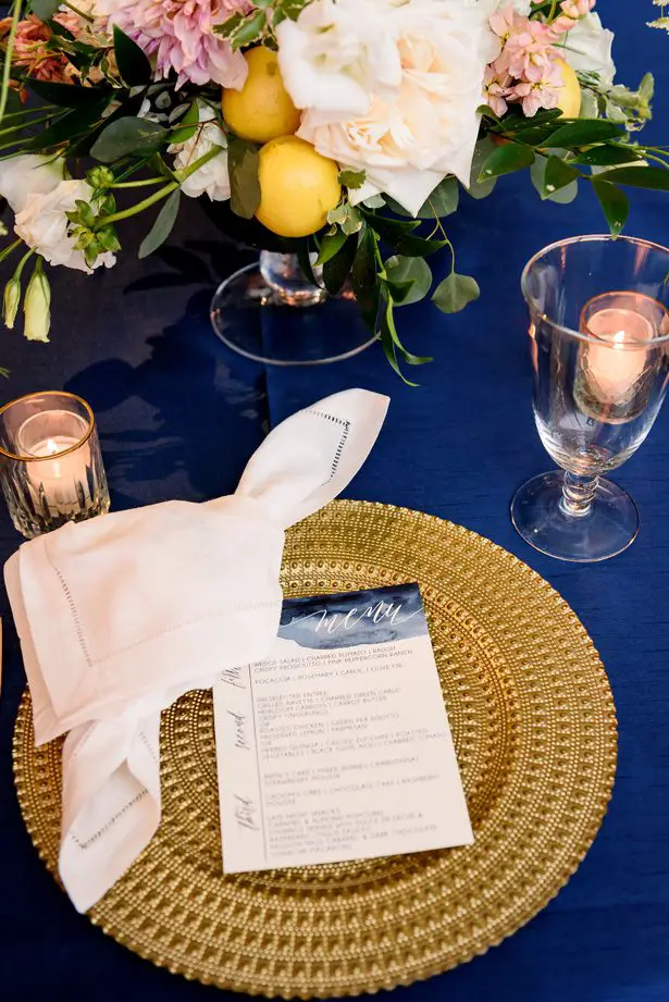 Gold and blue wedding place setting - Jenny DeMarco Photography