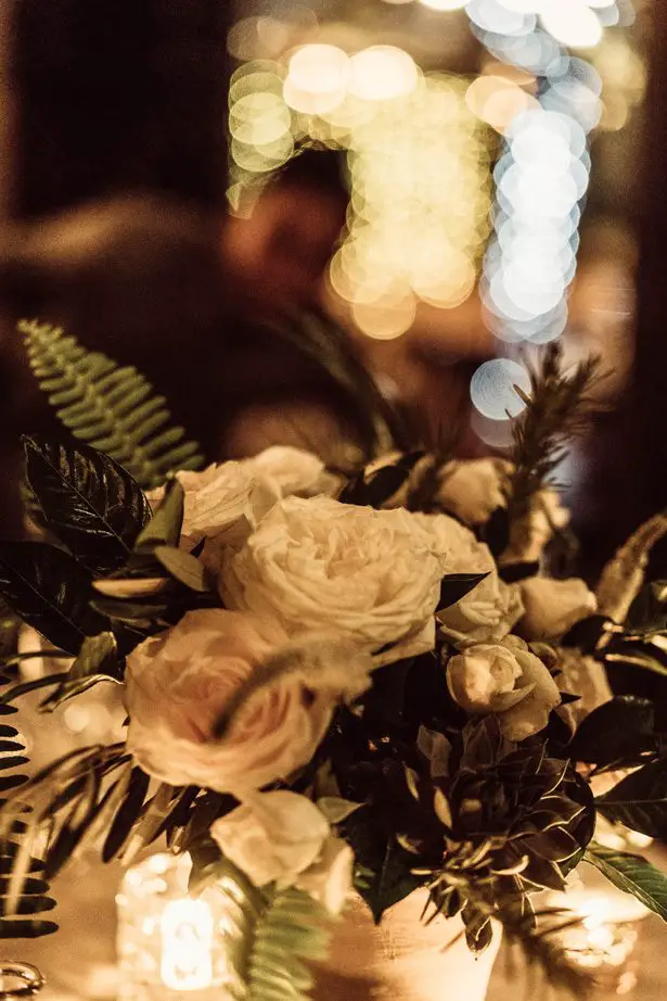 Low wedding centerpiece with white flowers and greenery - Robbie Ziegler Photography