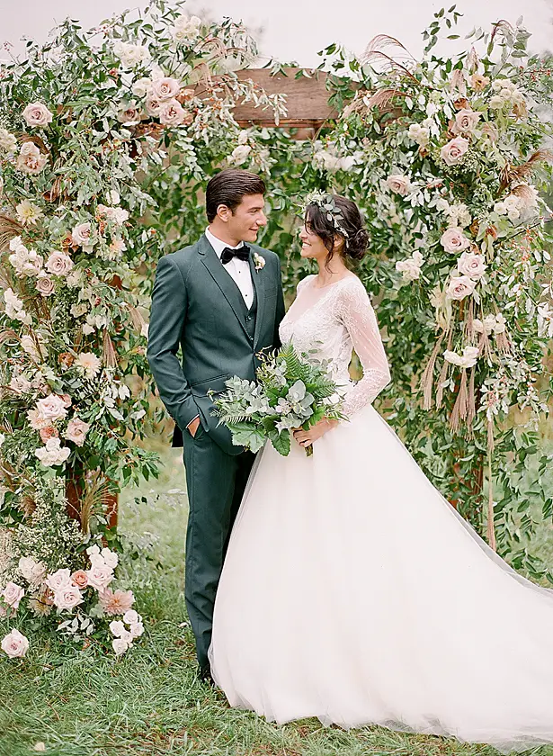 Classic bride and groom portrait with flower arbor Barn Wedding - Twah Photography