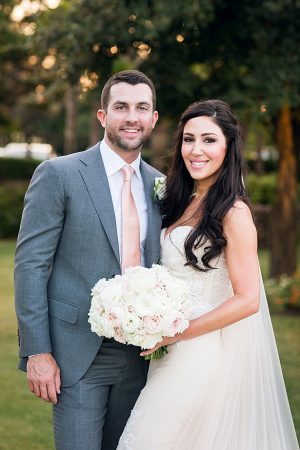 Classic couple's photo of bride and groom with lace wedding dress and grey suit A Glamorous Wedding with Fireworks - Rachael Hall Photography