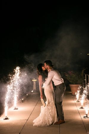 Epic reception exit with bride and groom kissing and fireworks A Glamorous Wedding with Fireworks - Rachael Hall Photography