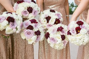 Luxe bridesmaids bouquets with white, burgundy and purple flowers and gold sequin bridesmaids dresses A Glamorous Wedding with Fireworks - Rachael Hall Photography
