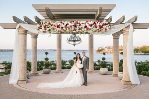 Luxurious lake wedding with flower pergola ceremony decor A Glamorous Wedding with Fireworks - Rachael Hall Photography