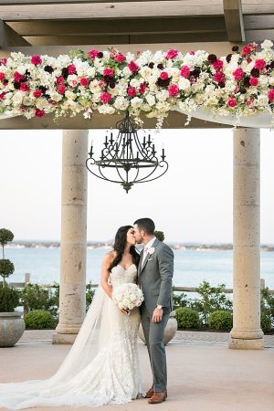 Romantic photo of couple kissing under wedding pergola A Glamorous Wedding with Fireworks - Rachael Hall Photography