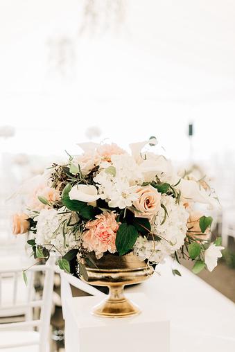 Low glam wedding centerpieces of blush and ivory floral and white feathers  designe…