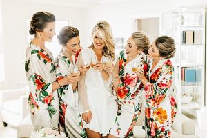 Matching Bridesmaids Getting Ready Robes with bride drinking champagne - Jenna Bacholt Photography