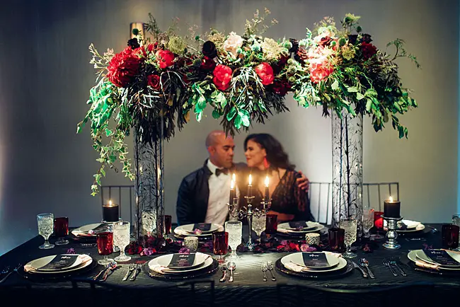 Bold black and red wedding reception decor with bride and groom - Little Honey Photography