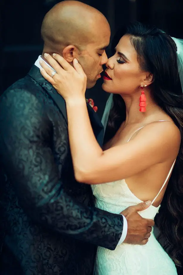 Romantic photo of bride and groom kissing - Little Honey Photography