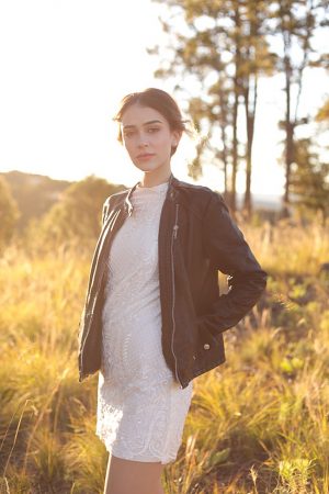 Edgy bridal look with short lace wedding dress and black leather jacket - Photo: Tiffany Hudson Films