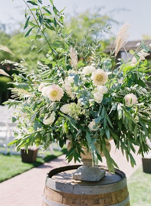 Elegant wedding ceremony flowers with white and greenery on a wine barrel for a Napa Wedding- O’Malley Photography