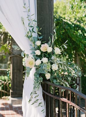 Gorgeous wedding ceremony arbor decor with white flowers and greenery - O’Malley Photography