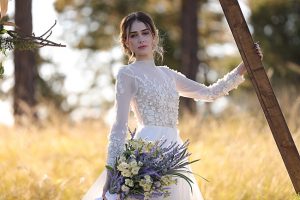 House of Maganda wedding ceremony with bride in long sleeve floral wedding dress - Photo: Tiffany Hudson Films