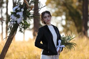 Unique wedding arbor and bride in black leather jacket - Photo: Tiffany Hudson Films