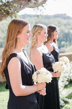 Bridesmaids in black dresses with white bouquets and hair down - Purewhite Photography