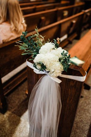 Church wedding flowers for pew with white flowers and tulle - Photography: NST Pictures
