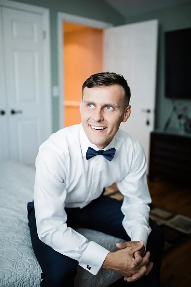 Classic getting ready photo of groom on his wedding day in a bowtie - Bluespark Photography
