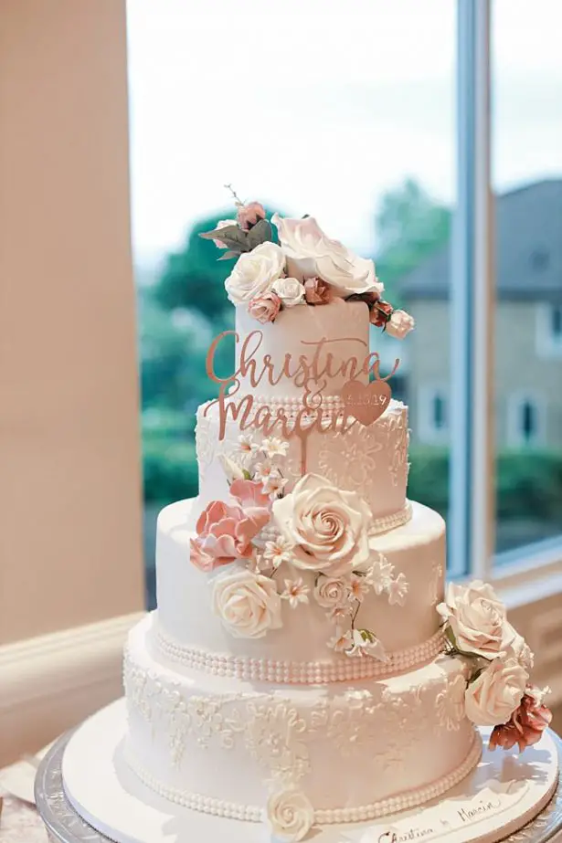 Country Club Wedding cake with tons of flowers and a unique cake topper - Photography: NST Pictures